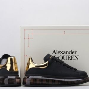 Selling alexander mcqueen black and gold sneakers.